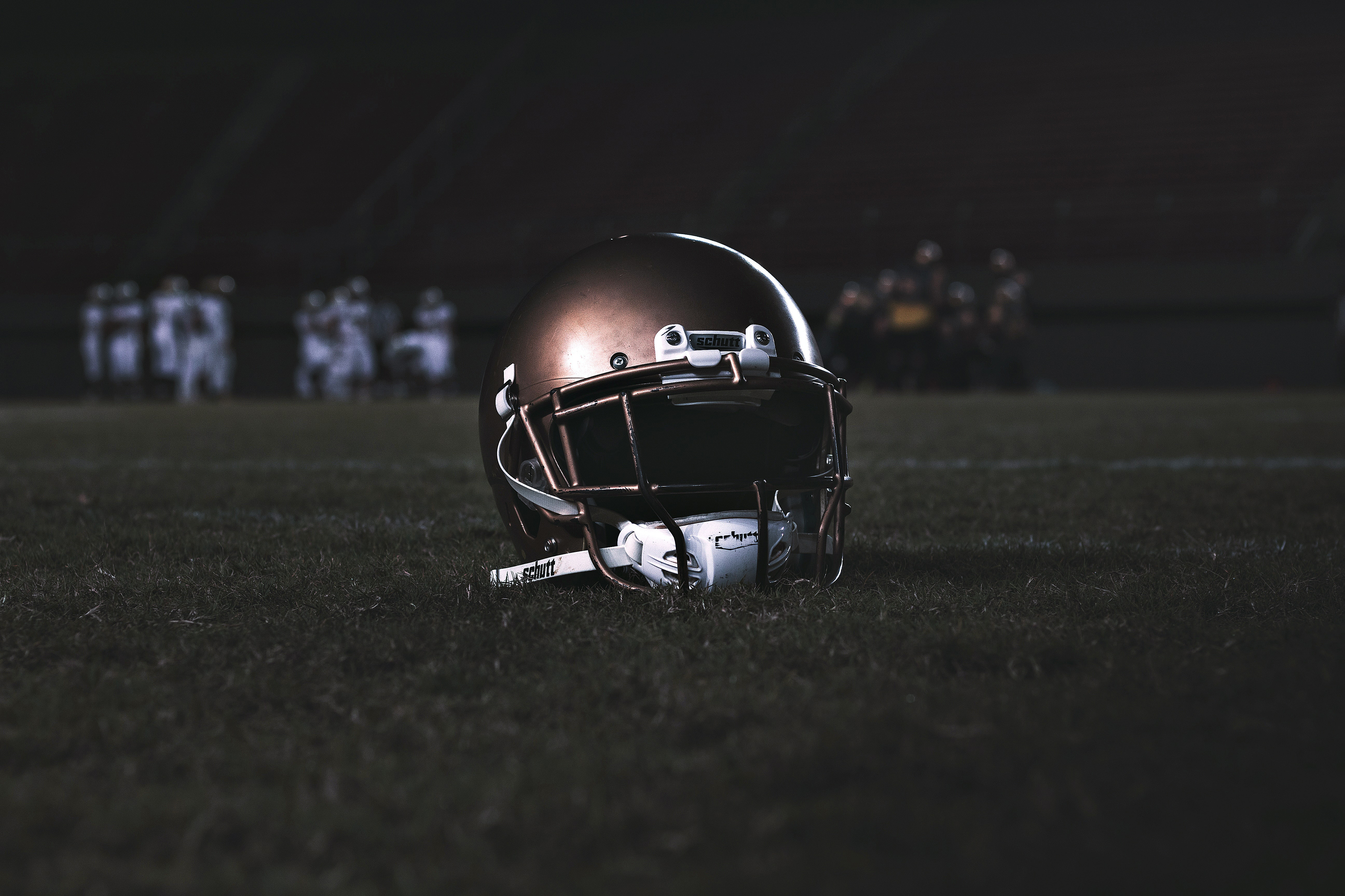 Football helmet resting on the football field.