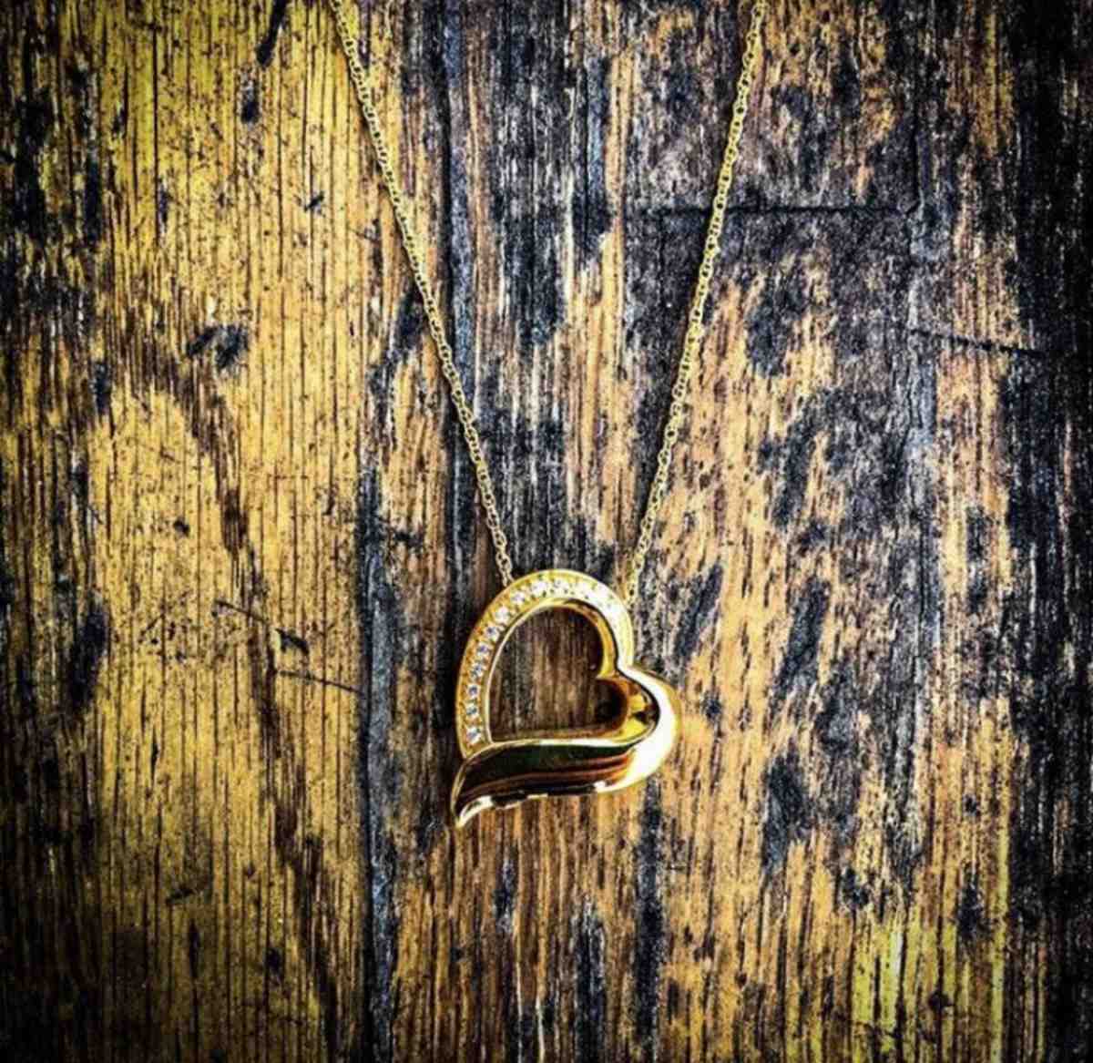 Gold heart cremation jewelry pendant.