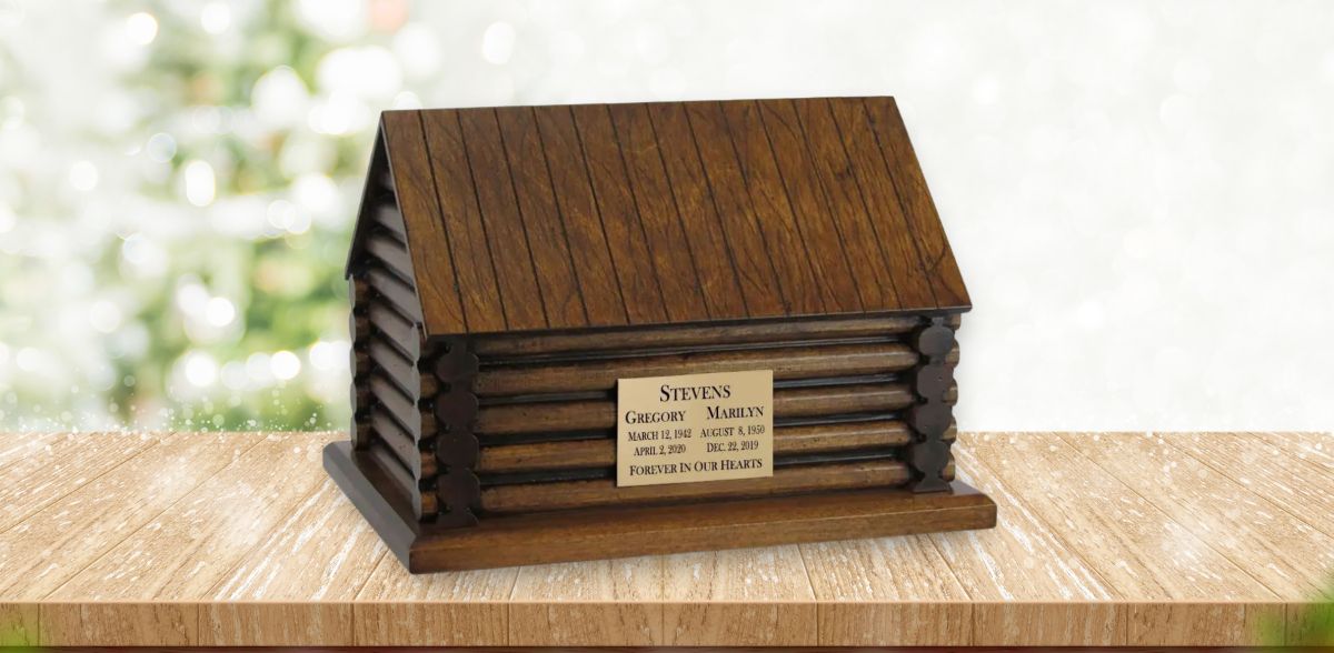 Custom log cabin urn (by In The Light Urns) sitting on a table.