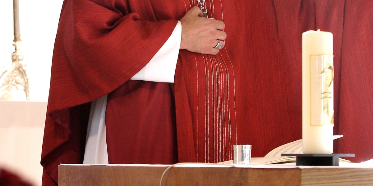 Catholic Bishop in red robes at the altar.