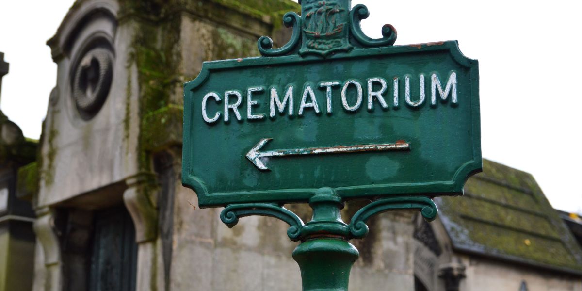 Old, green, metal crematorium street sign.