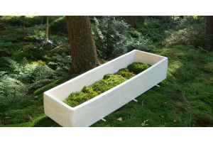 White mushroom coffin similar looking to styrofoam, much sturdier made of harden and dry wood chips and mycelium.