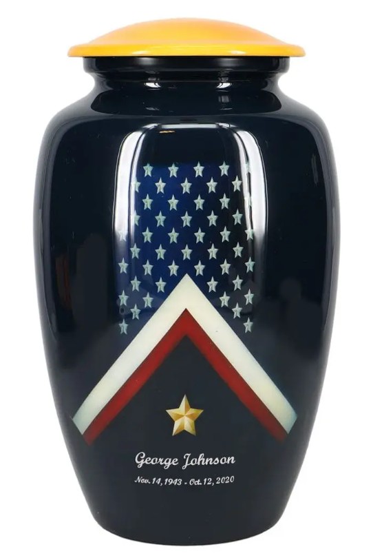 The Veteran Flag Cremation Urn is made from metal and shows the stars and stipes with a gold star.