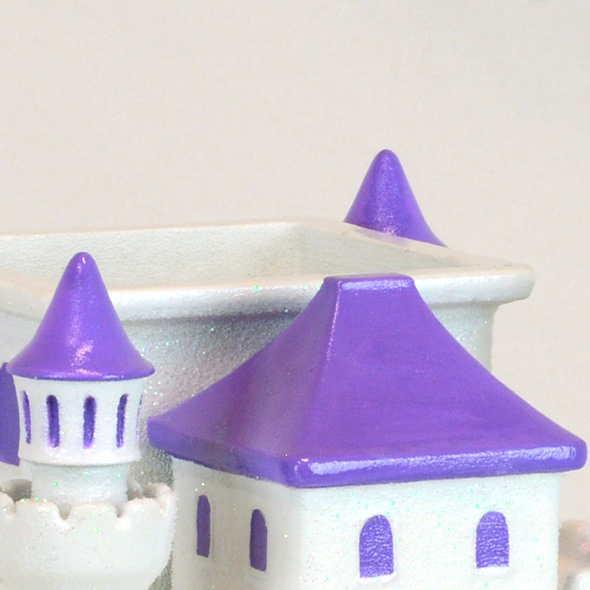 A close-up of the princess castle 3D-printed urn showing the roof removed to insert ashes.