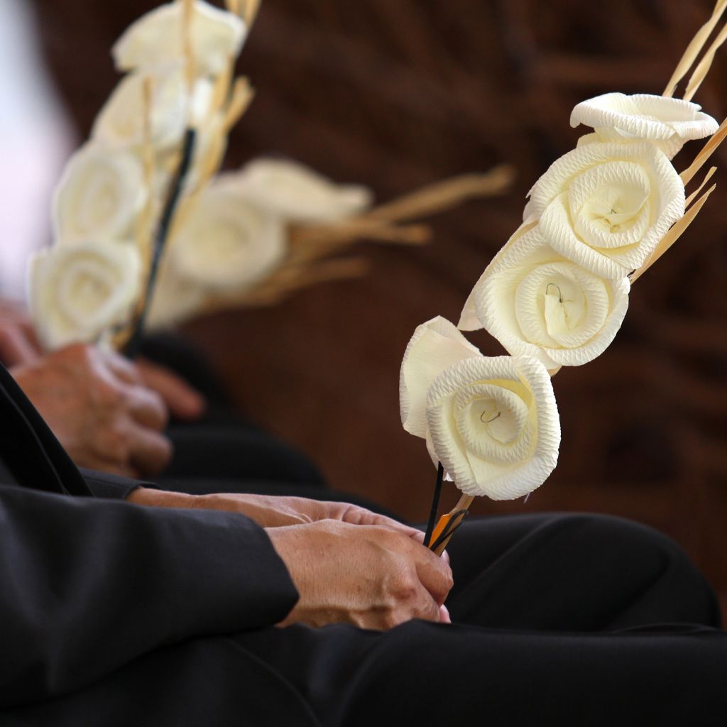 Holding flowers at a funeral service.