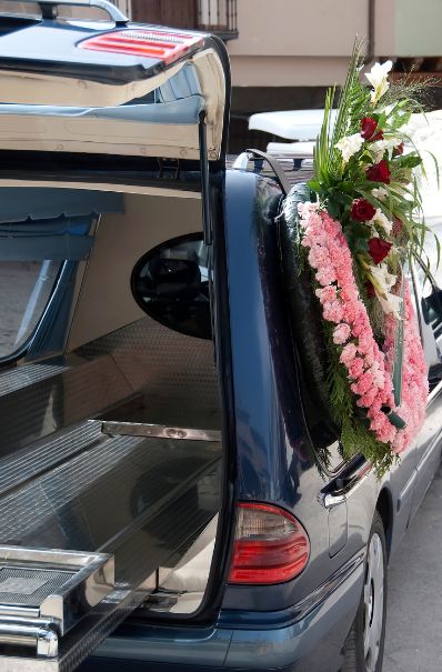 Funeral hearse with trunk open.