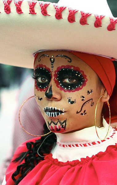 Woman with painted face for Dia de los Muertos.