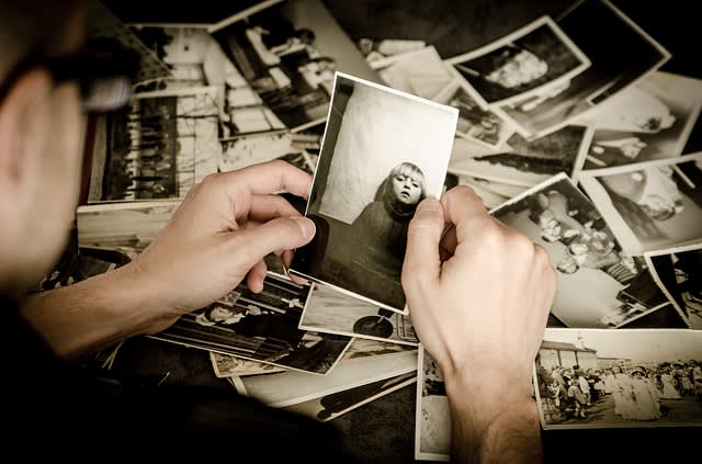 Man looking at a photo of his lost loved one.