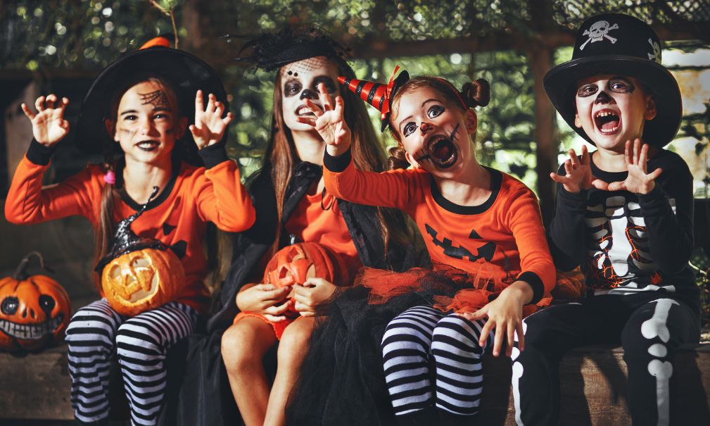 Group of children in matching Halloween costumes.