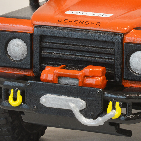 A close-up of the front bumper of the 3D-printed Land Rover urn.