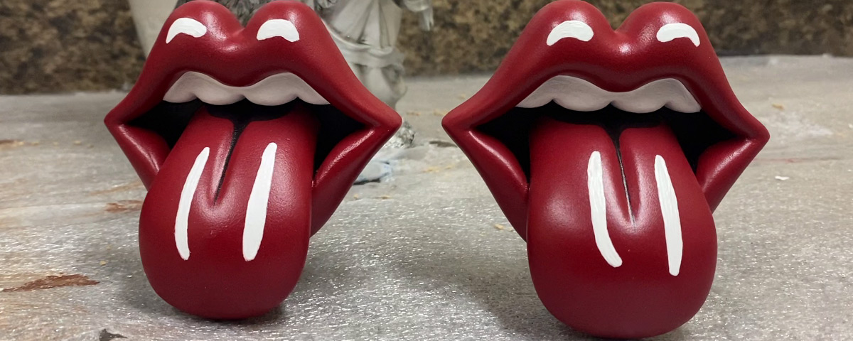 Two finished Rolling Stones' lips 3D prints side by side.