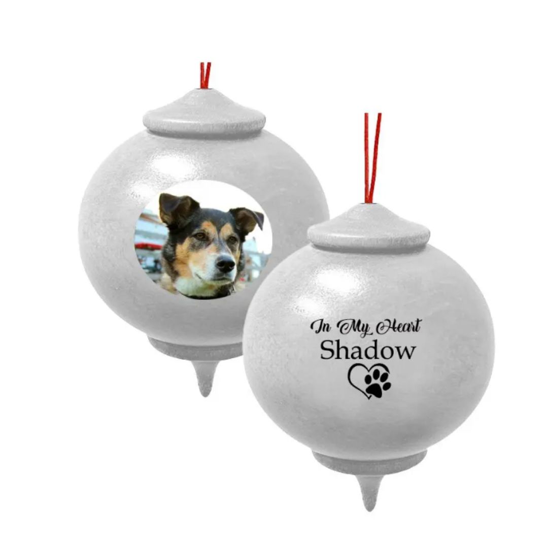 The In My Heart Paw Print Photo Wood Bulb Ornament Urn is a wooden memorial Christmas ornament urn for ashes, with an aluminum threaded closure, to tightly secure the ashes.