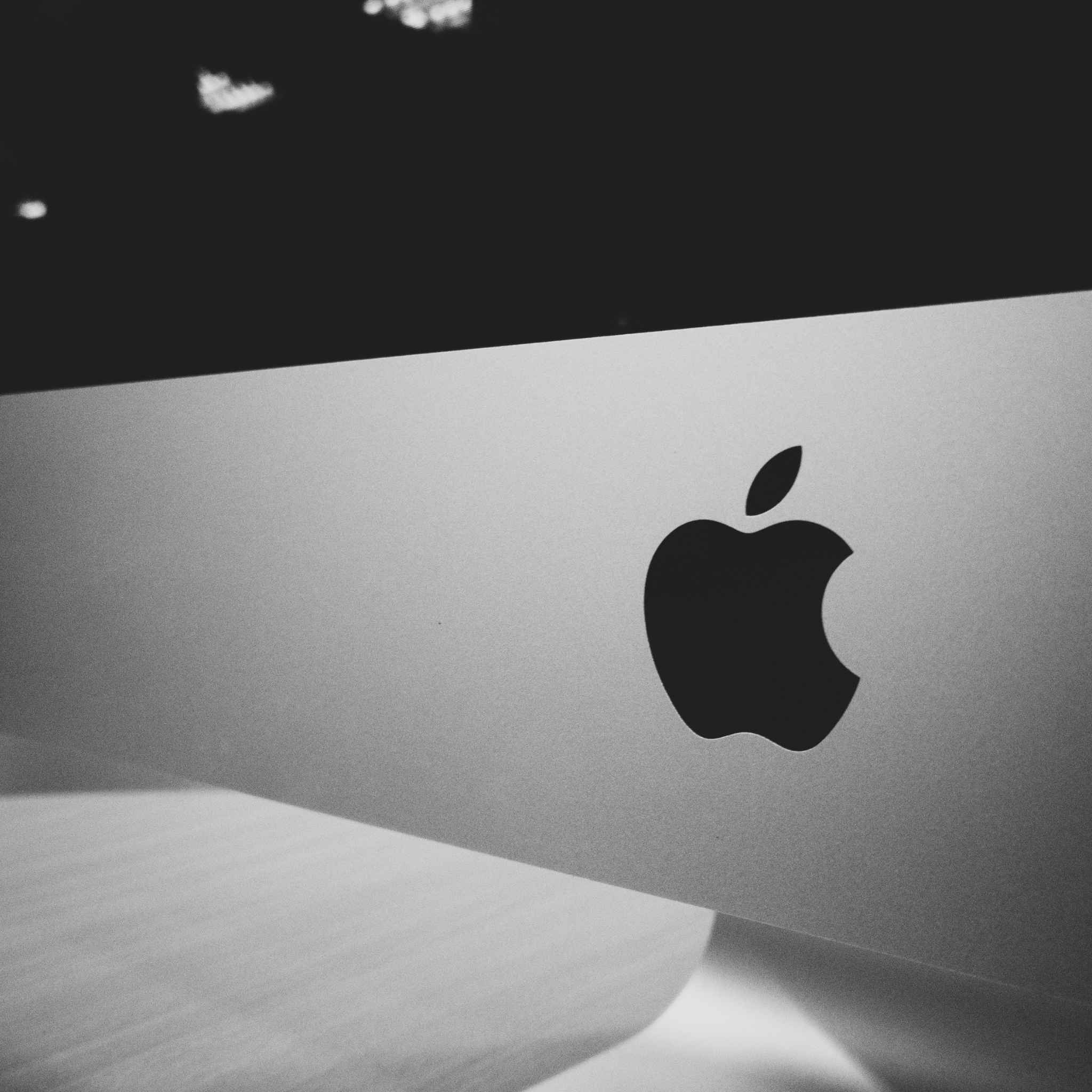 Close-up of Apple logo on iMac desktop computer.